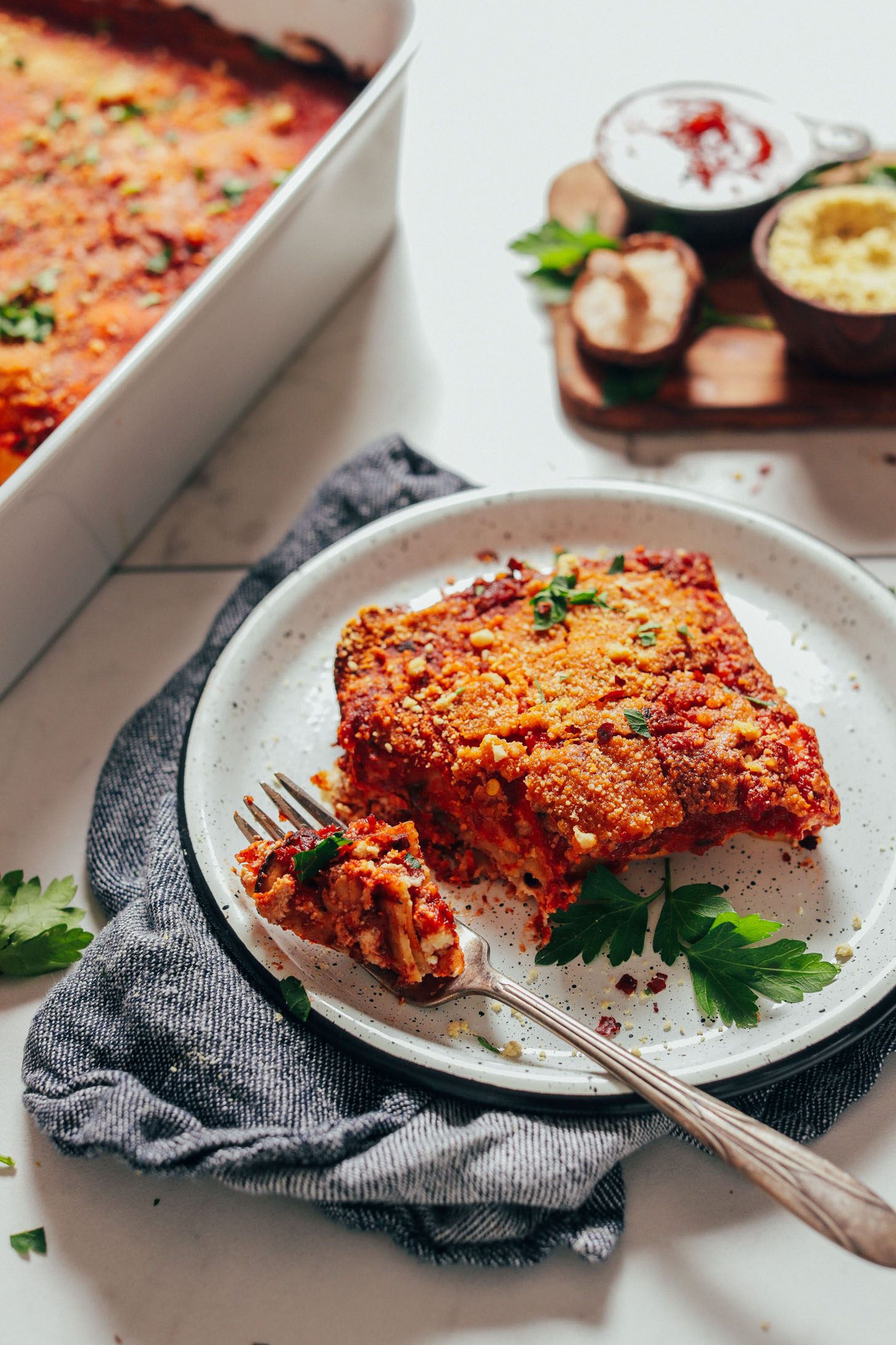 Using a fork to grab a bite of our flavorful Vegan Lasagna recipe