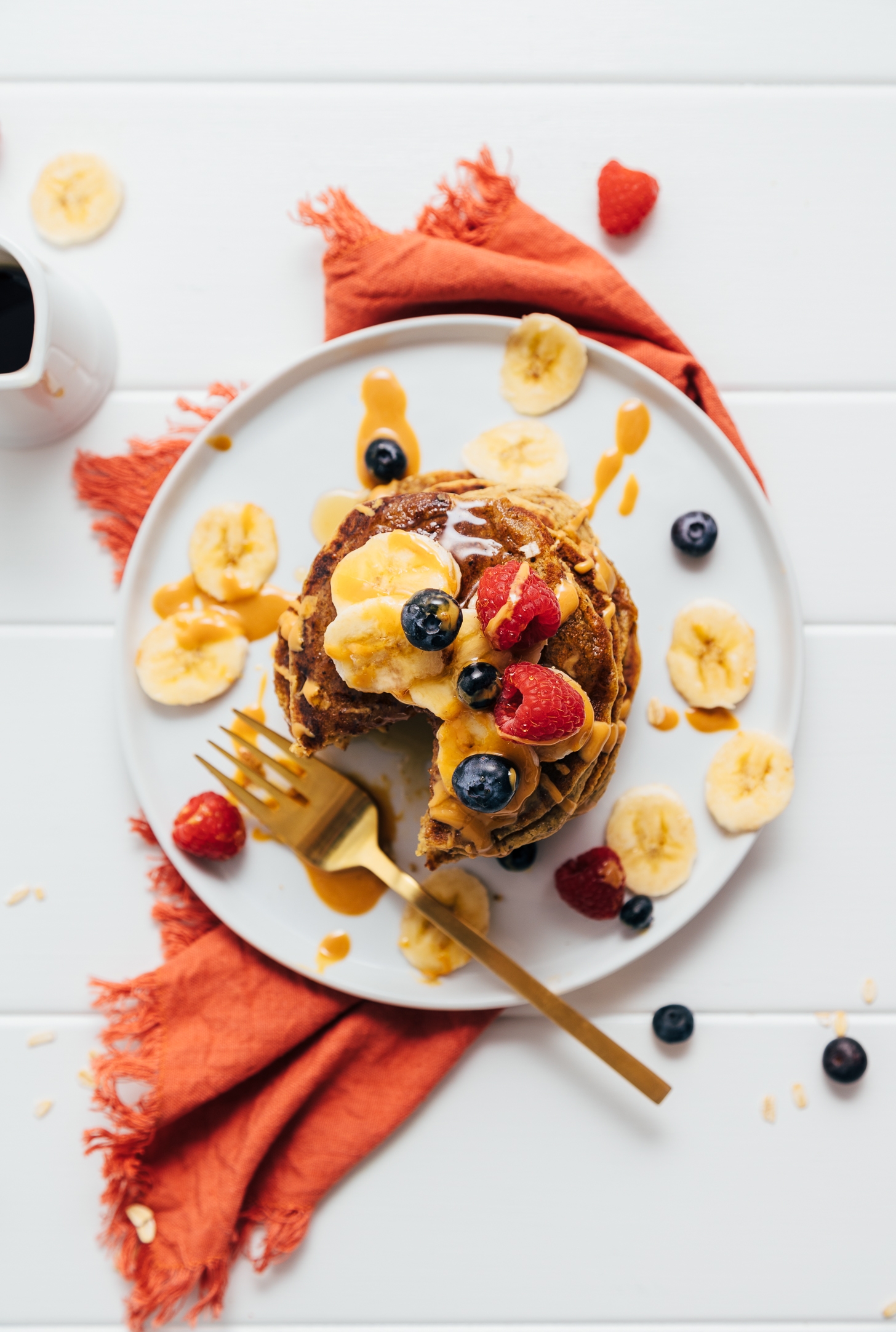 Top down shot of a stack of Peanut Butter Protein Pancakes topped with fresh fruit
