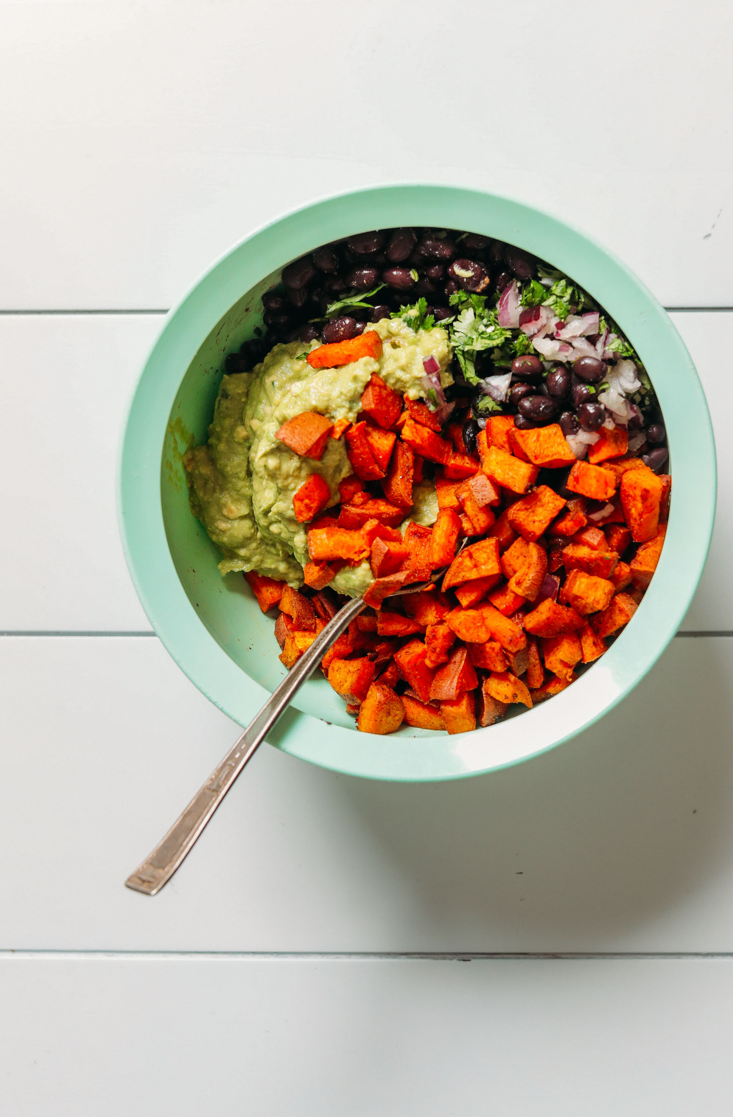 Big bowl filled with ingredients for making our Southwest Sweet Potato Black Bean Dip recipe