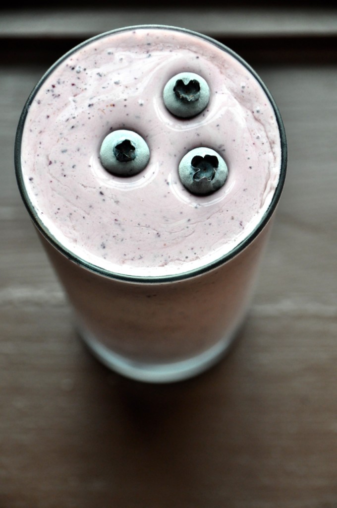 Glass of our Blueberry Maple Protein Shake with blueberries on top