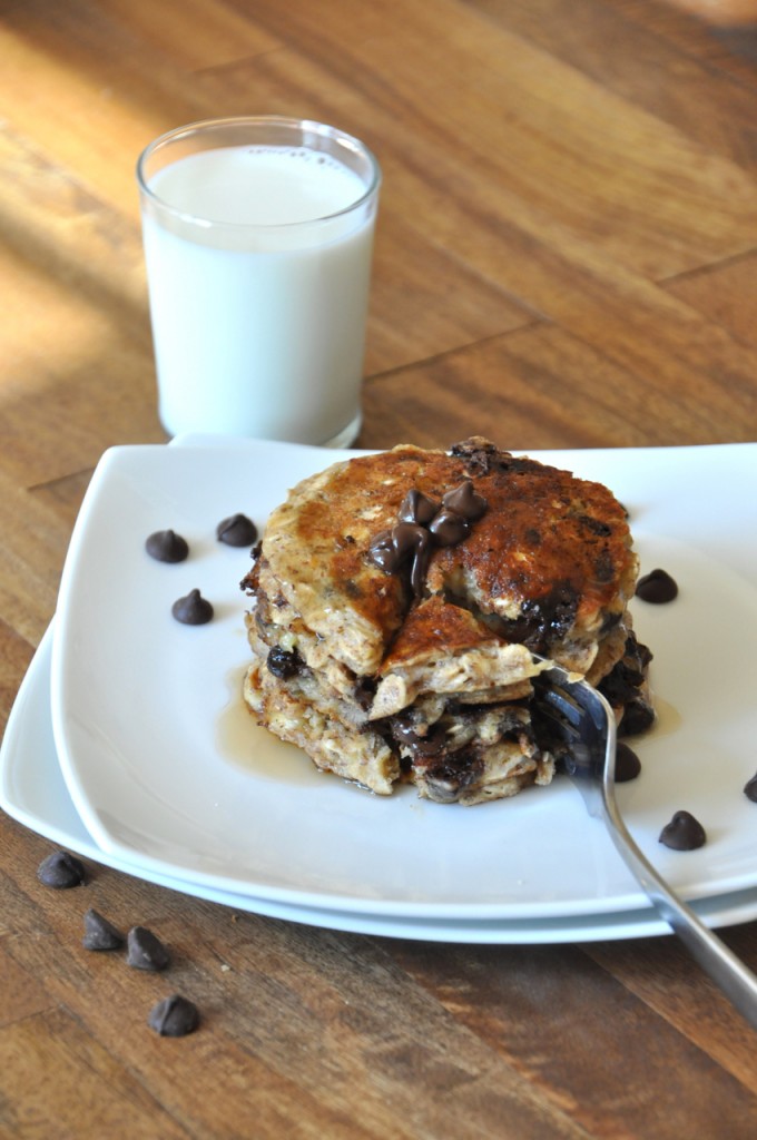 Using a fork to cut into a stack of our incredible vegan Chocolate Chip Oatmeal Pancakes recipe