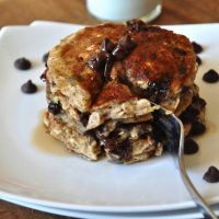 Using a fork to grab a big bite of our delicious Chocolate Chip Oatmeal Pancakes