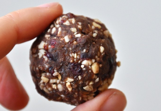 Holding up a bite of dough for our Chocolate Cashew Cookie Larabar Pops recipe