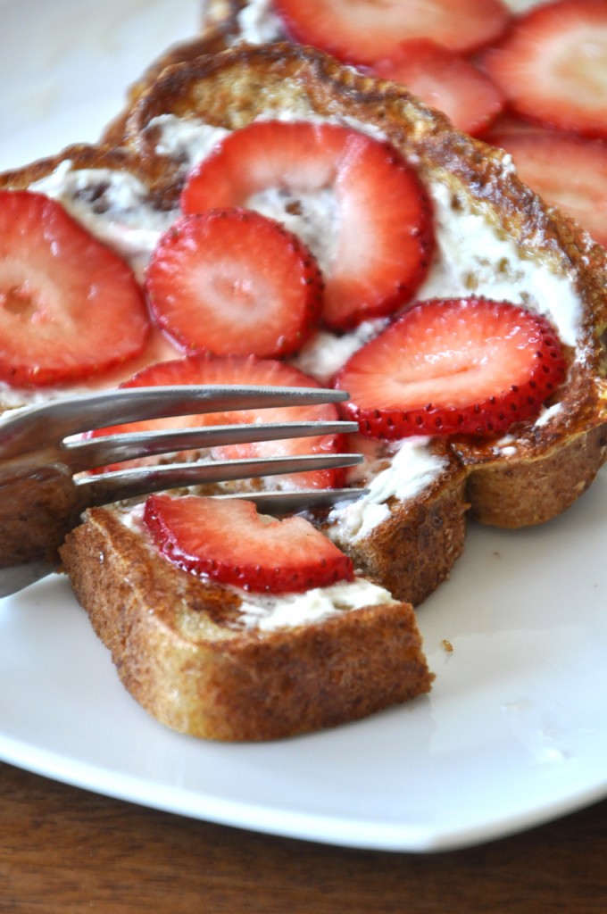 Using a fork to grab a bite of Strawberry Danish French Toast made with fresh strawberries
