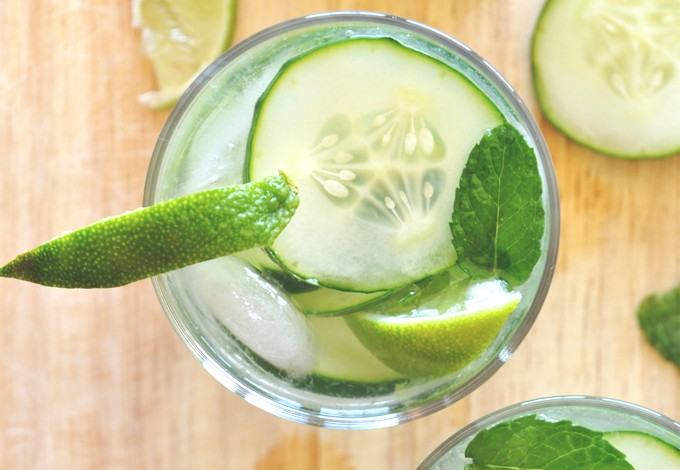 Top down shot of a refreshing Cucumber Cooler Cocktail with lime and mint