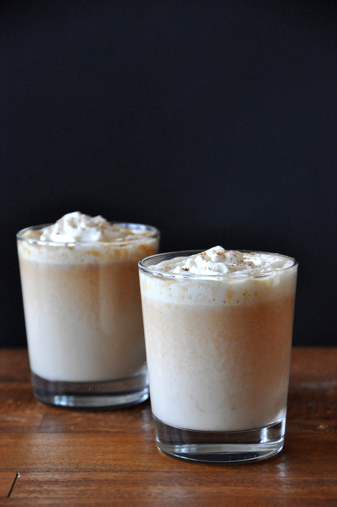 Glasses of our Boozy Pumpkin White Hot Chocolate recipe topped with whipped cream