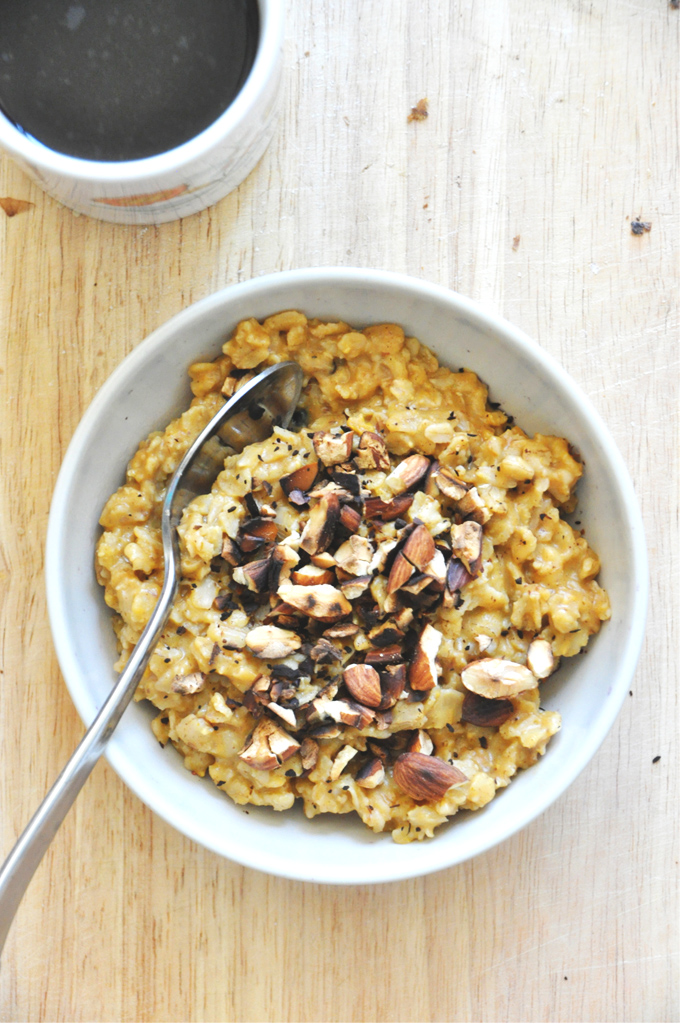 Bowl of Creamy Pumpkin Oats topped with Blueberries and Toasted Almonds