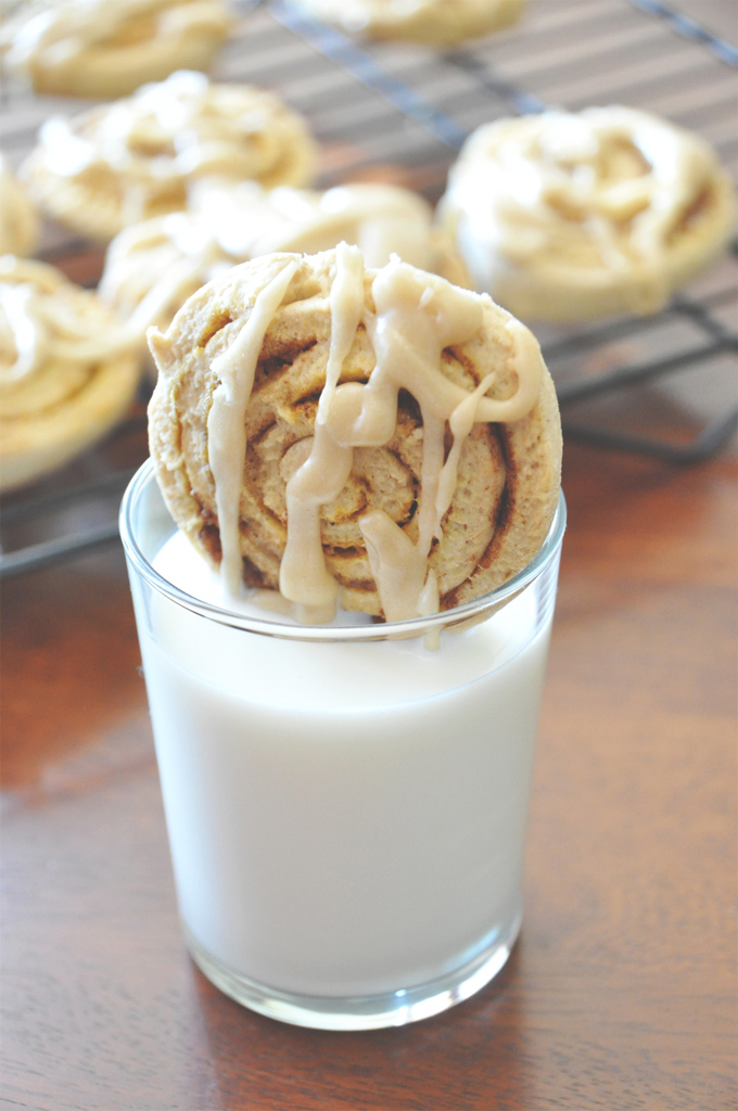 Dipping a Pumpkin Cinnamon Roll Cookie into a glass of milk