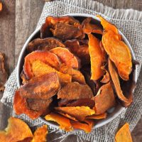 Top down shot of an overflowing bowl of Baked Sweet Potato Chips