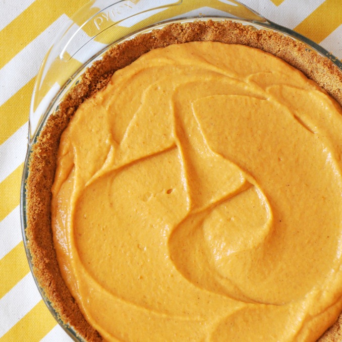 Pie dish filled with our Creamy Pumpkin Pie recipe made with a graham cracker crust