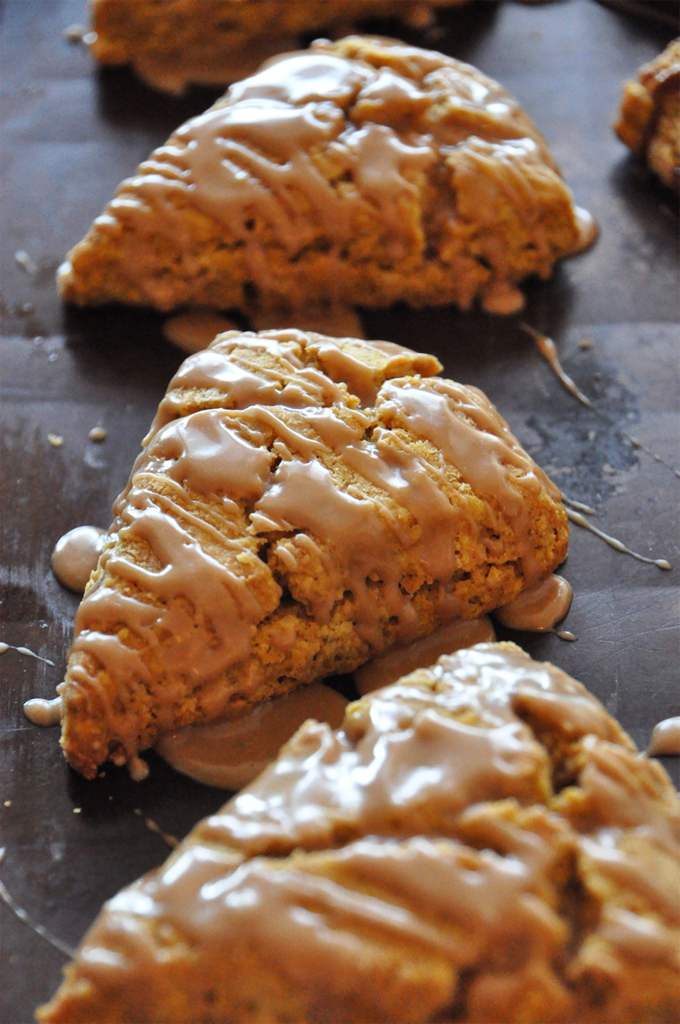 Close up shot of delicious homemade Pumpkin Scones drizzled with Maple Glaze