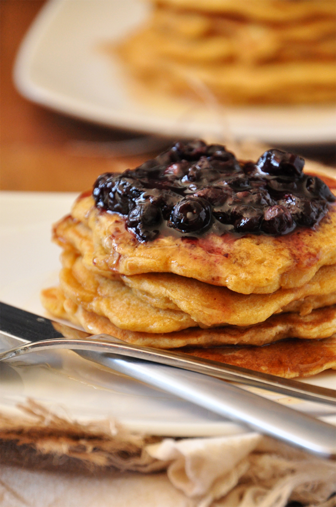 Two plates of our Whole Wheat Griddle Cakes with Blueberry Orange Compote recipe