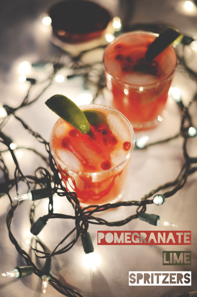 Christmas lights surrounding glasses of our Pomegranate Lime Spritzers recipe