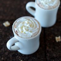 Mugs of Ginger Hot Chocolate topped with whipped cream