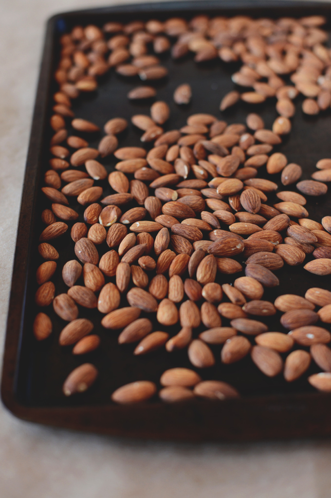 Baking sheet of toasted almonds for making gluten-free vegan Almond Joy Spread