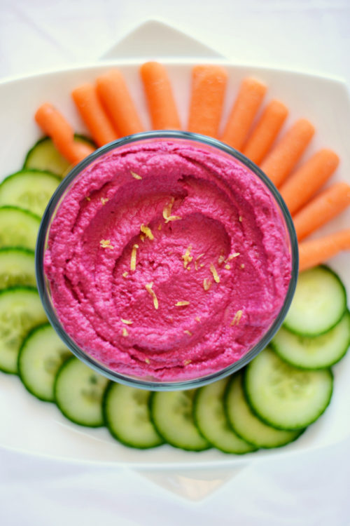 Dish of Roasted Beet Hummus with sliced vegetables for a healthy snack