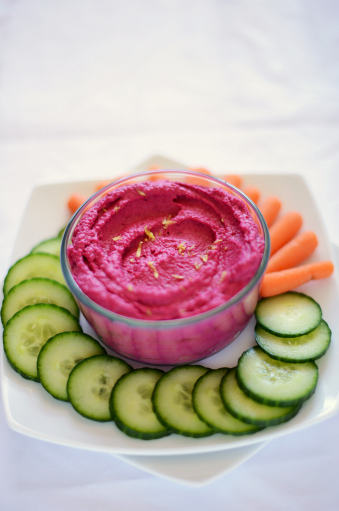 Sliced veggies and a bowl of our Roasted Beet Hummus recipe