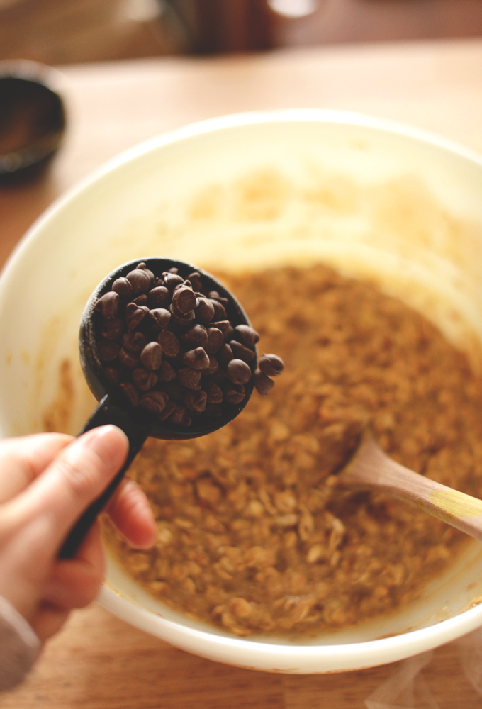 Pouring chocolate chips into our gluten-free vegan cookie dough batter