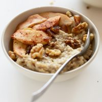 Bowl of Date-Sweetened Apple Pie Oatmeal topped with walnuts