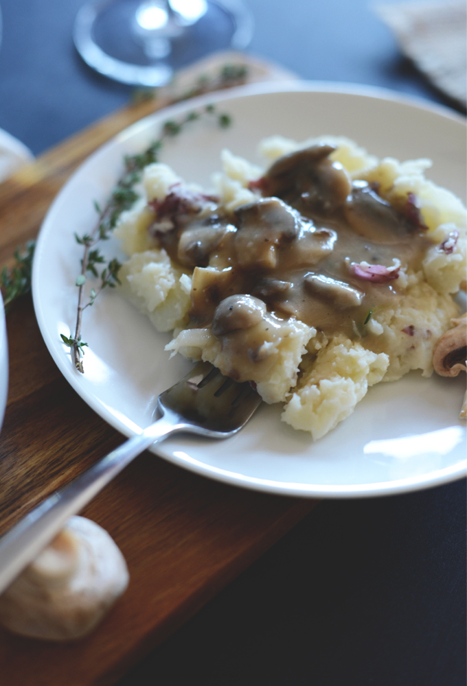 Using a fork to grab a bite of Mashed Potatoes with Mushroom Gravy