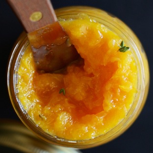 Knife resting in a jar of homemade Orange Thyme Jam