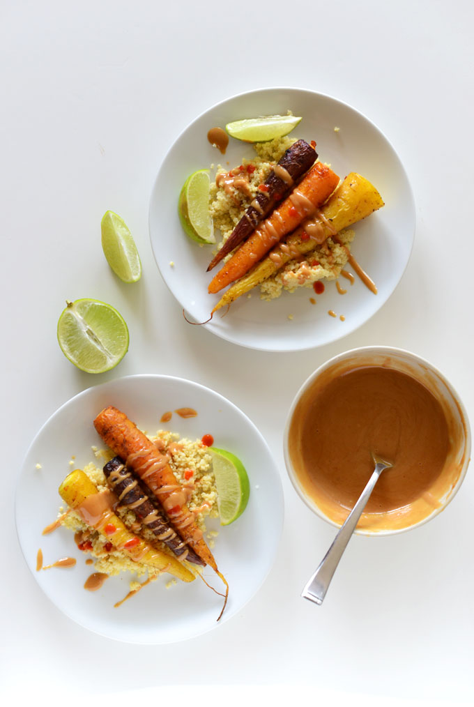 Curry Roasted Carrot Plate over millet with lime wedges and bowl of peanut sauce