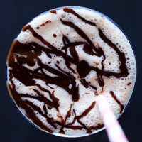 Top down shot of a Frozen Blended Vegan White Russian topped with chocolate sauce