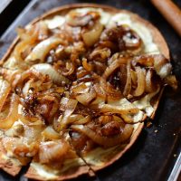 Homemade Goat Cheese & Caramelized Onion Pizza on a baking sheet