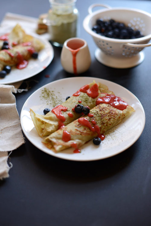 Plate of our Gluten-Free Green Tea Crepes recipe drizzled with fresh berries