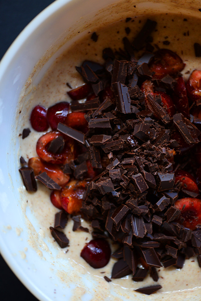 Bowl of muffin batter with fresh cherries and dark chocolate