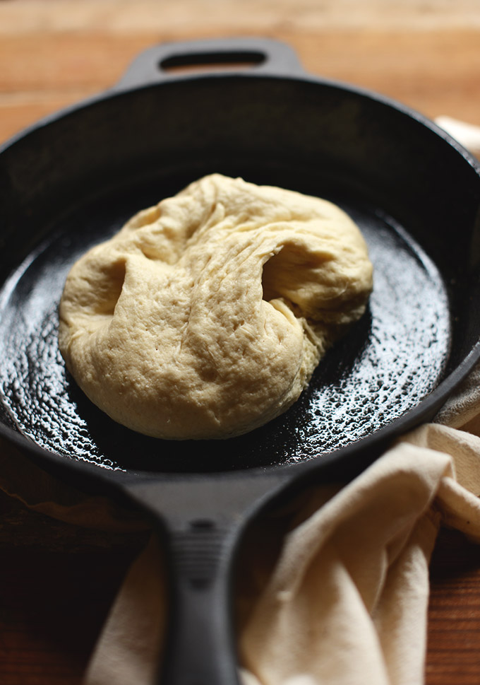 Pizza dough in an oiled cast-iron skillet