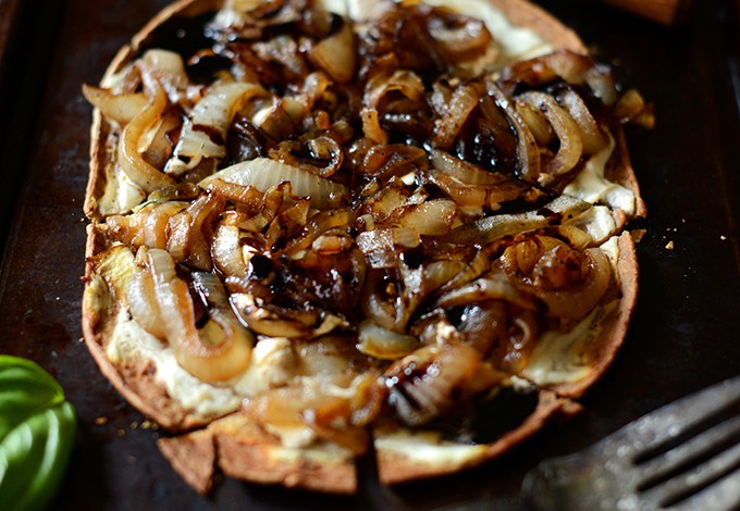 Homemade Goat Cheese Caramelized Onion Pizza on a baking sheet