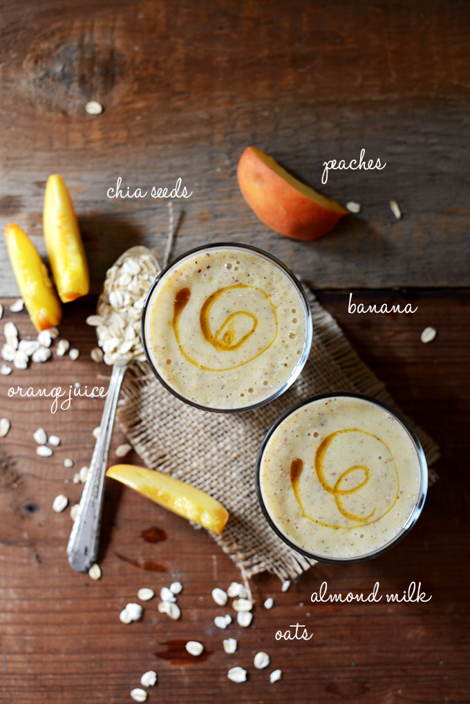 Two glasses of our Peach Oat Chia Smoothie surrounded by ingredients used to make it