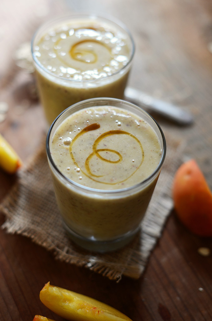 Two short glasses of our Vegan Peach Oat Chia Smoothie