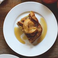 Plate with a slice of Apple French Toast Baked and maple syrup