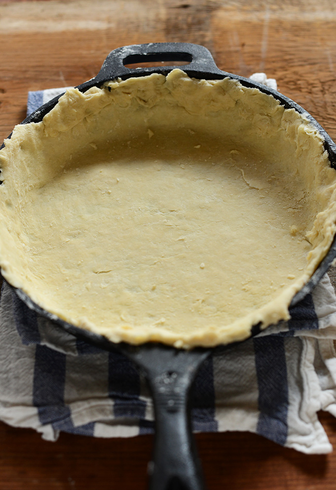 Cast-iron skillet filled with pie crust