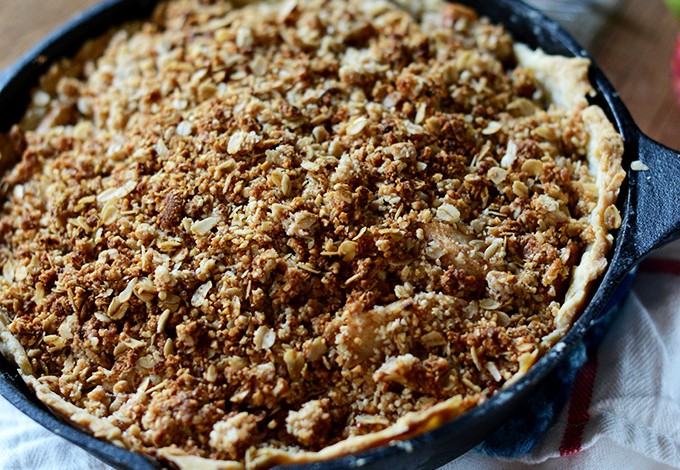 Skillet filled with vegan Deep Dish Apple Crumble Pie