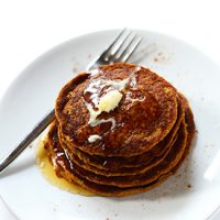 Plate of Vegan Pumpkin Spice Pancakes topped with syrup