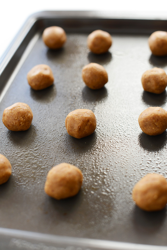 Baking sheet with balls of Vegan PB&J Thumbprint Cookie batter