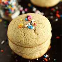 Gluten-Free Sugar Cookies topped with sprinkles on a baking sheet