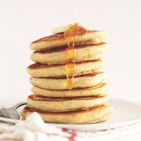 Maple syrup dripping off a stack of pancakes made with our GF Pancake Mix