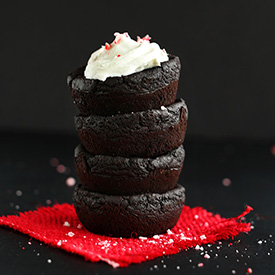 Stack of four Peppermint Black Bean Brownies with the top one frosted