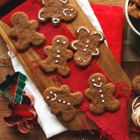 Vegan Gluten-Free Gingerbread Cookies on a cutting board topped with red fabric