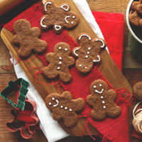 Vegan Gluten-Free Holiday Gingerbread Cookies alongside cookie cutters and a rolling pin