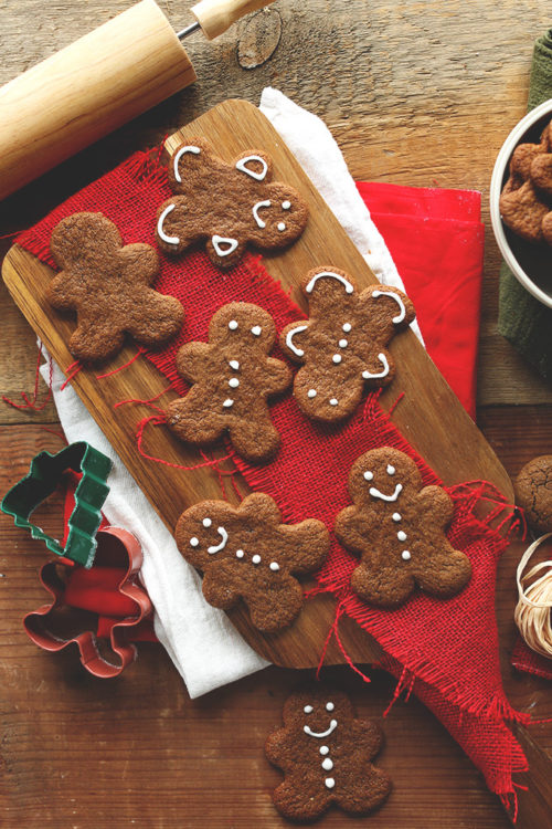 Vegan Gluten-Free Holiday Gingerbread Cookies alongside cookie cutters and a rolling pin