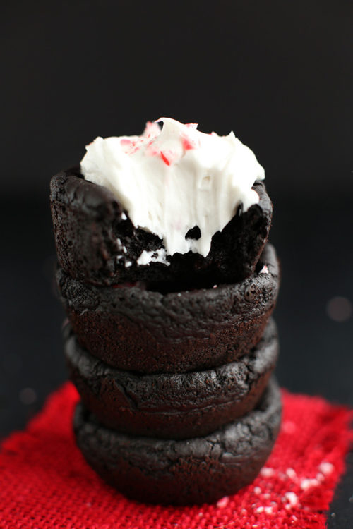 Stack of Vegan Peppermint Brownies with the top one frosted with coconut whipped cream