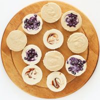 Cutting board with several Mini Vegan Cheesecakes of three different flavors