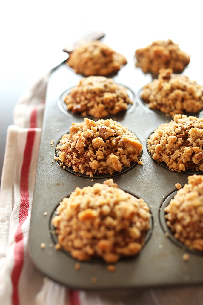 Freshly baked Vegan Banana Crumble Top Muffins in a muffin tin