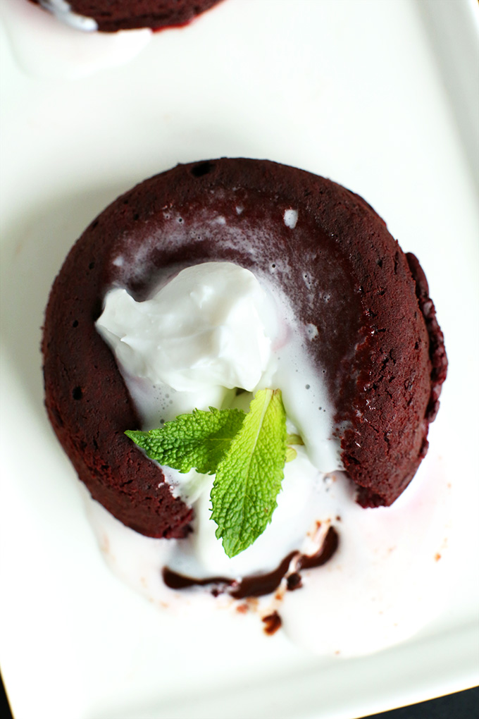 Plate of Vegan Molten Lava Cake topped with coconut whipped cream and fresh mint