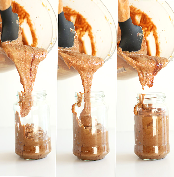 Pouring homemade Chocolate Pretzel Peanut Butter into a jar